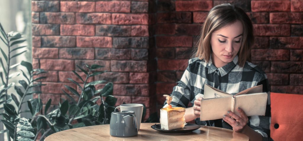 Beautiful girl reads a book for morning rituals for success 