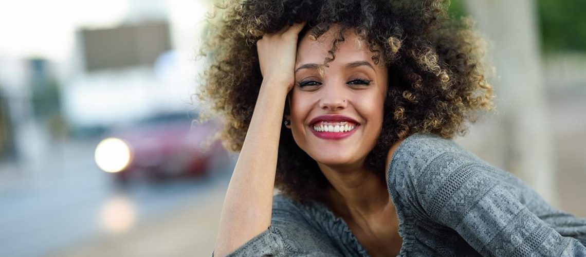 young-black-woman-with-afro-hairstyle-smiling-in-JZ27STU.min_.jpg